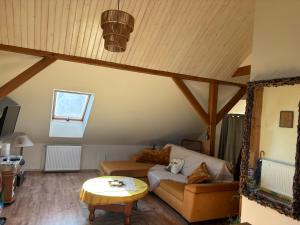 a living room with a couch and a table at Apartament 2-pokojowy, z atrakcjami dla dzieci in Kolonia Salnia