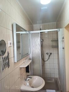 a bathroom with a sink and a shower at Weingut Villa Raevenhof in Ayl +16 photos