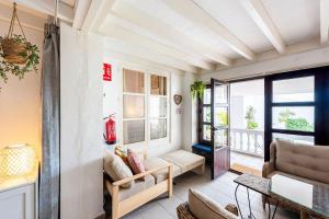 a living room with a couch and a window at Casa Merlin Capistrano playa in Nerja