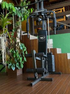 a gym equipment on a wooden floor with plants at Pousada Convés - Ilha Grande in Praia de Araçatiba