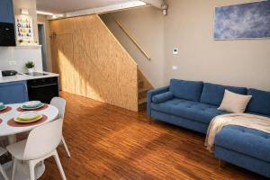 a living room with a blue couch and a table at Easy Loft Milano in Crescenzago