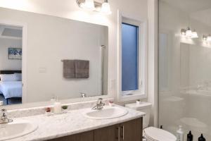 a bathroom with a sink and a toilet and a mirror at Spacious 4BR Home with EV Charger in Cambridge +77 photos