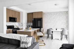 a living room with a couch and a kitchen at Spacious 4BR Home with EV Charger in Cambridge