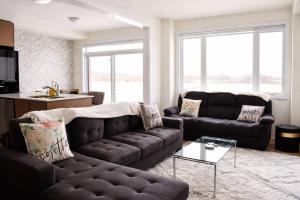 a living room with two couches and a table at Spacious 4BR Home with EV Charger in Cambridge