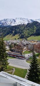 a view of a town with a train in a parking lot at Tolle zentrale Wohnung in Engelberg
