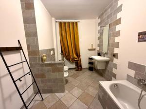 a bathroom with a tub and a toilet and a sink at Ca Rene in Savigliano +4 photos