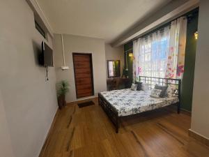 a bedroom with a bed and a window at GD Homestay in Shillong