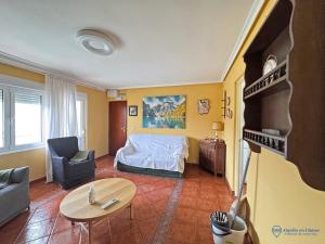 a bedroom with a bed and a table in a room at Apartamento Barro Playa in Barro de Llanes