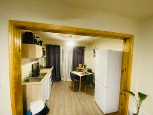 a kitchen with a white refrigerator and a table at La loge in Marigot