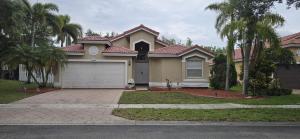 a house with a garage and palm trees at Across from Sawgrass Mall- Next to Amerant Bank Arena in Sunrise