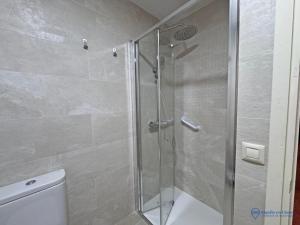 a shower with a glass door in a bathroom at Apartamento Barro Playa in Barro de Llanes +12 photos