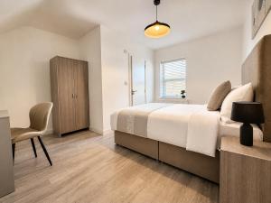 a bedroom with a bed and a chair and a window at ExecStay - Central Reading - Premium Solo Stays in Reading