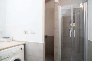 a shower with a glass door in a bathroom at Urban Studio Apartment in Brescia