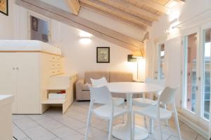 a kitchen and dining room with a table and chairs at Urban Studio Apartment in Brescia +12 photos