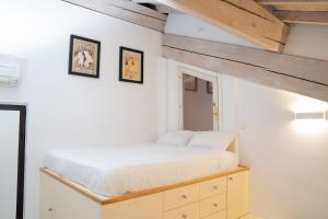 a bedroom with a bed and two pictures on the wall at Urban Studio Apartment in Brescia