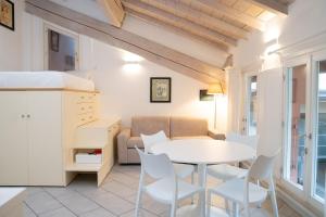 a kitchen and living room with a table and chairs at Urban Studio Apartment in Brescia