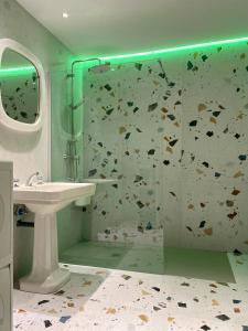 a bathroom with a shower with a sink and a glass shower door at Castro Romano VUT 7712 AS in Gijón +20 photos