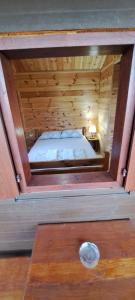 a room with a bed in a wooden cabin at TreeHouse in Bar +2 photos