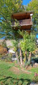 a tree house with a deck on top of it at TreeHouse in Bar