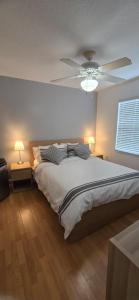 a bedroom with a bed with a ceiling fan at Across from Sawgrass Mall- Next to Amerant Bank Arena in Sunrise