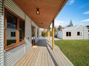 a porch of a house with a wooden deck at 1860 Lawrence Cottage in Lawrence