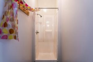 a bathroom with a shower with a shower curtain at Camp Val Notre-Dame in Herouxville +10 photos