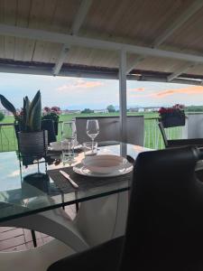 a table with glasses and a plate on top of it at Mini Loft con terrazza vista Alpi in Vinovo