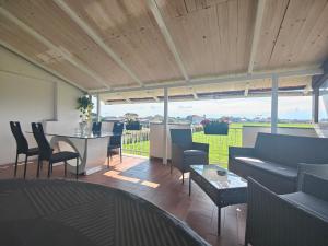 a living room with chairs and a table with a view at Mini Loft con terrazza vista Alpi in Vinovo