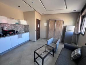 a living room with a couch and a table at Appartement No 2 à Tamraght in Tamraght Ouzdar