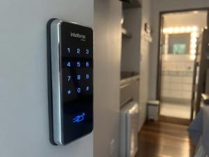 a remote control on the wall of a kitchen at Bela Vista Hospedagem in Joinville +32 photos