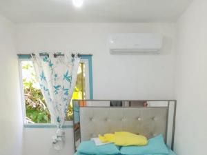 a bedroom with a bed and a window at Two-Bedroom Apartment with Ocean View in La Ciénaga