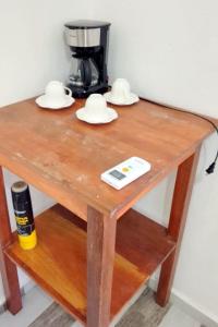 a wooden table with hats and a coffee maker at Two-Bedroom Apartment with Ocean View in La Ciénaga