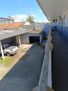 a car parked in a parking lot next to a house at Pousada Beira Mar in Matinhos