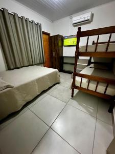 a bedroom with a bed and a television in it at Hostel Salazar in Campo Grande +11 photos