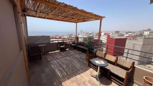 a balcony with chairs and a view of a city at Appartement No 2 à Tamraght in Tamraght Ouzdar