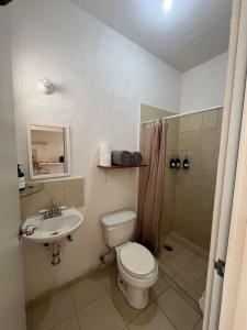 a bathroom with a toilet and a sink and a shower at Casa Claliz in Los Algodones