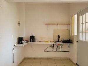a kitchen with a counter and a sink at Casa Claliz in Los Algodones