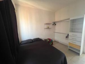 a small bedroom with a bed and a closet at Casa Claliz in Los Algodones