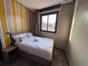 a small bedroom with a bed and a window at Appartement No 2 à Tamraght in Tamraght Ouzdar