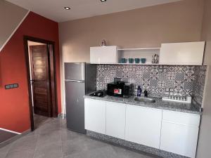 a kitchen with a sink and a refrigerator at Appartement No 2 à Tamraght in Tamraght Ouzdar +27 photos