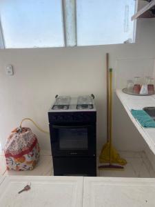 a stove in the corner of a kitchen at Antonia Hospedaria 1 in Búzios
