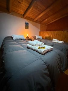 two large beds in a room with wooden ceilings at Gr Turismo in Los Molles +21 photos