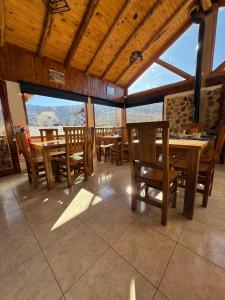 a dining room with tables and chairs and windows at Gr Turismo in Los Molles