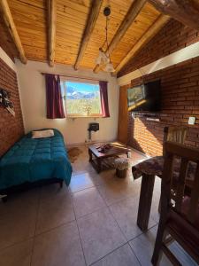 a bedroom with a bed and a flat screen tv at Gr Turismo in Los Molles