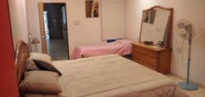 a bedroom with a bed and a dresser and a mirror at Posada Alto Verde in Belén