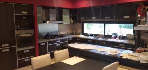 a large kitchen with a large island in the middle at Posada Alto Verde in Belén