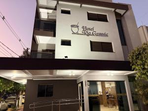 a building with a sign on the side of it at Hotel Rio Grande in Dourados +4 photos