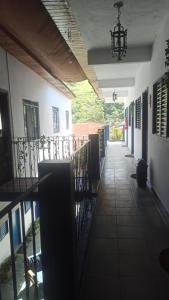 an empty hallway of a building with a chandelier at Pousada Regis Bocaina SJB in São José do Barreiro