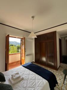 a bedroom with a large bed and a balcony at LuminHouse Addaura Pool in Palermo