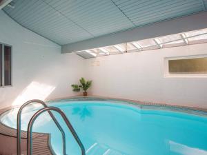 a large swimming pool in a room with a window at 8 person holiday home in Ørsted in Kare
